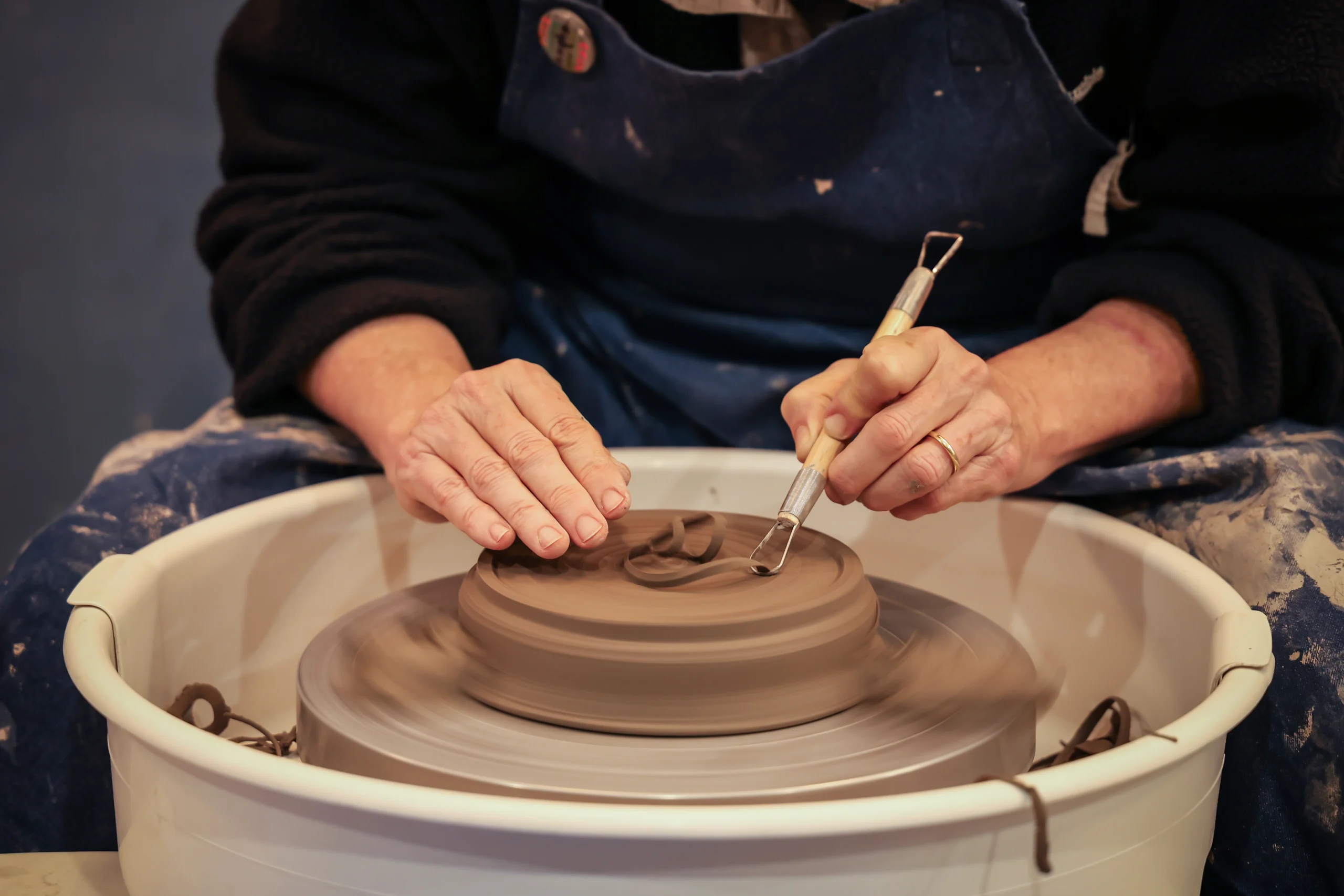 a person trimming a clay pot at Linlithgow Pottery